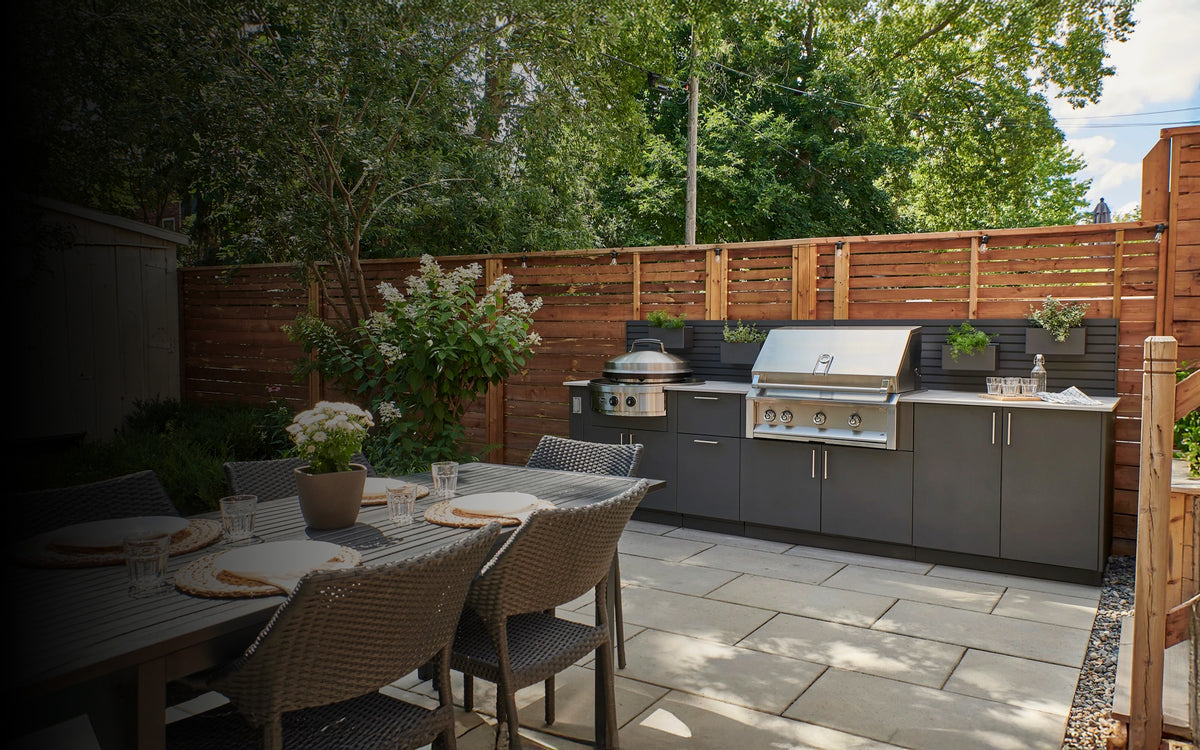 Urban Bonfire outdoor kitchen with a built-in grill and cooktop beside a dining area
