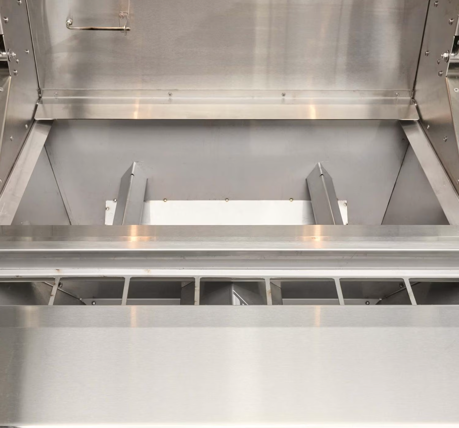 Inside view of pellet hopper on Coyote 28-Inch Built-In Pellet Grill