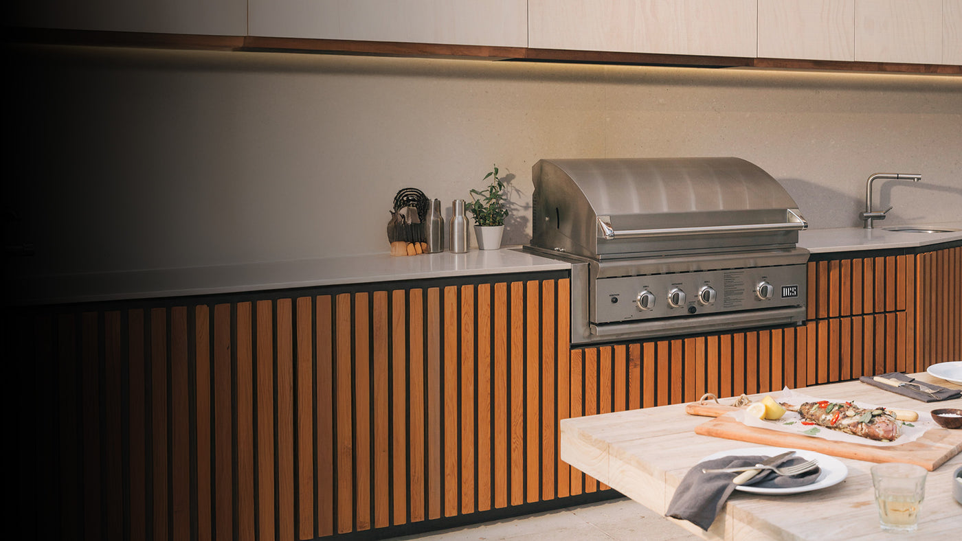 DCS Outdoor kitchen with a grill, dining area, and countertop.