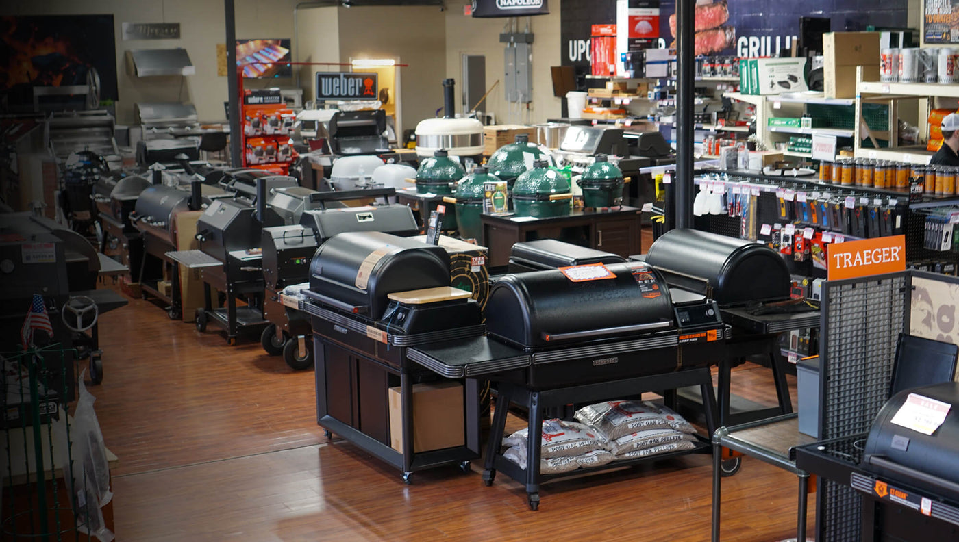 Interior of Texas Star Grill Shop showroom in Houston featuring a wide selection of premium grills including Traeger pellet grills, Big Green Egg ceramic kamados, and Weber charcoal grills.