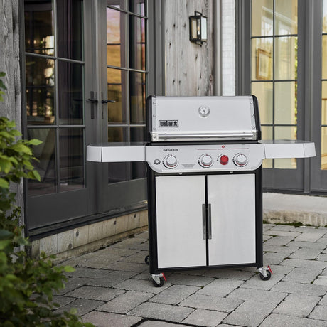 Weber Genesis SP-S-325 grill placed on patio outside double glass doors