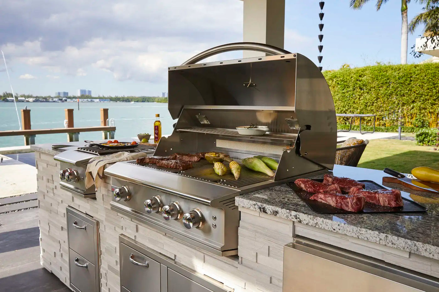 blaze grill and outdoor kitchen with delicious looking barbecue near a lake
