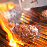 delicious looking burgers cooking hot and fast over with flare-ups on the napoleon prestige pro 825 built-in gas grill