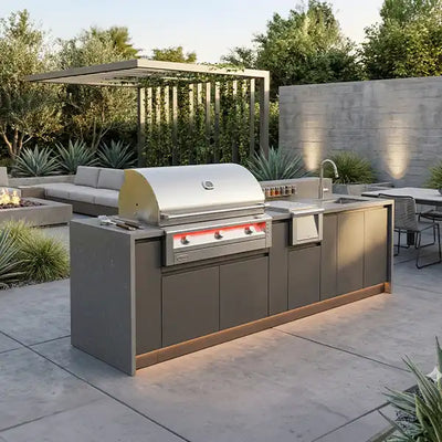 Outdoor kitchen with grill and sink area in a backyard setting