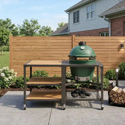 A detailed shot of a patio featuring a Big Green Egg kamado-style grill on its custom modular nest, with a multi-shelf extension table for preparation.