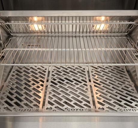 Interior cooking grates with lights on inside the Coyote 28-Inch Pellet Grill