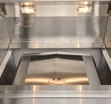 Heat deflector plate under the cooking grates in Coyote pellet grill