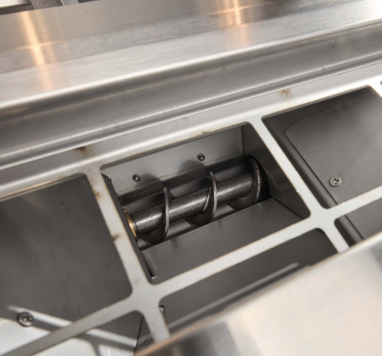 Auger system inside hopper of the Coyote Built-In Pellet Grill
