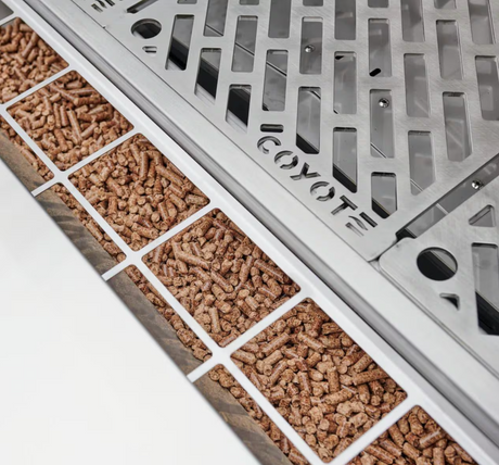 Pellet hopper showing wood pellets loaded into Coyote Smart Drop system.