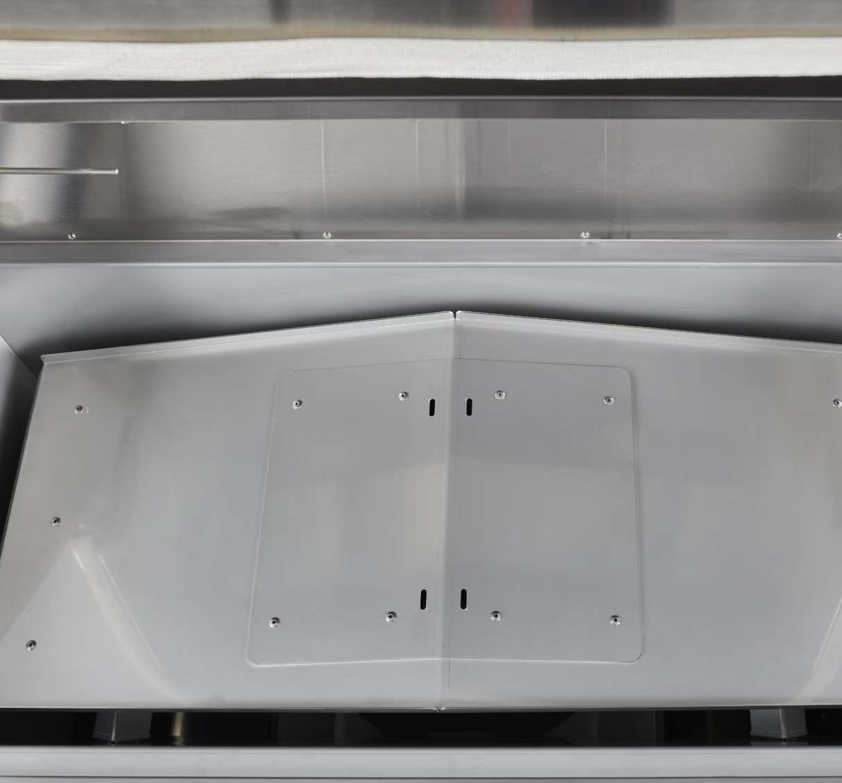 Interior heat deflector shield of the Coyote pellet grill.