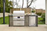 Coyote 36" pellet grill installed in a modern outdoor kitchen with the lid closed.