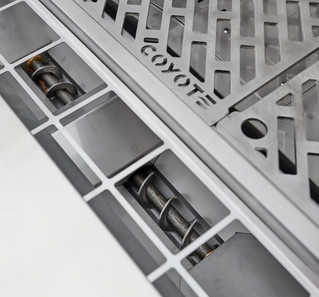 Smart Drop pellet feed system with dual augers inside Coyote pellet grill.