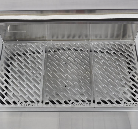 Close-up of stainless steel sear and smoke grates inside the Coyote pellet grill.