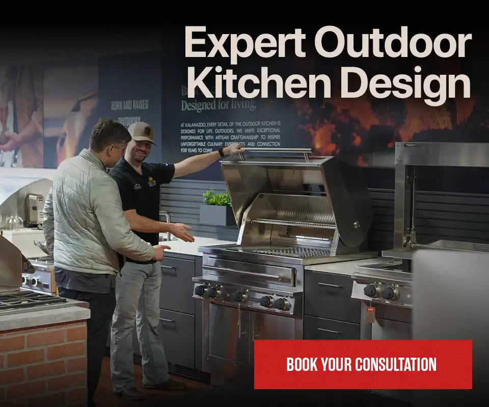 Expert Outdoor Kitchen Design. A customer and a design expert examining a premium built-in grill during a showroom consultation in Houston. Book your consultation.