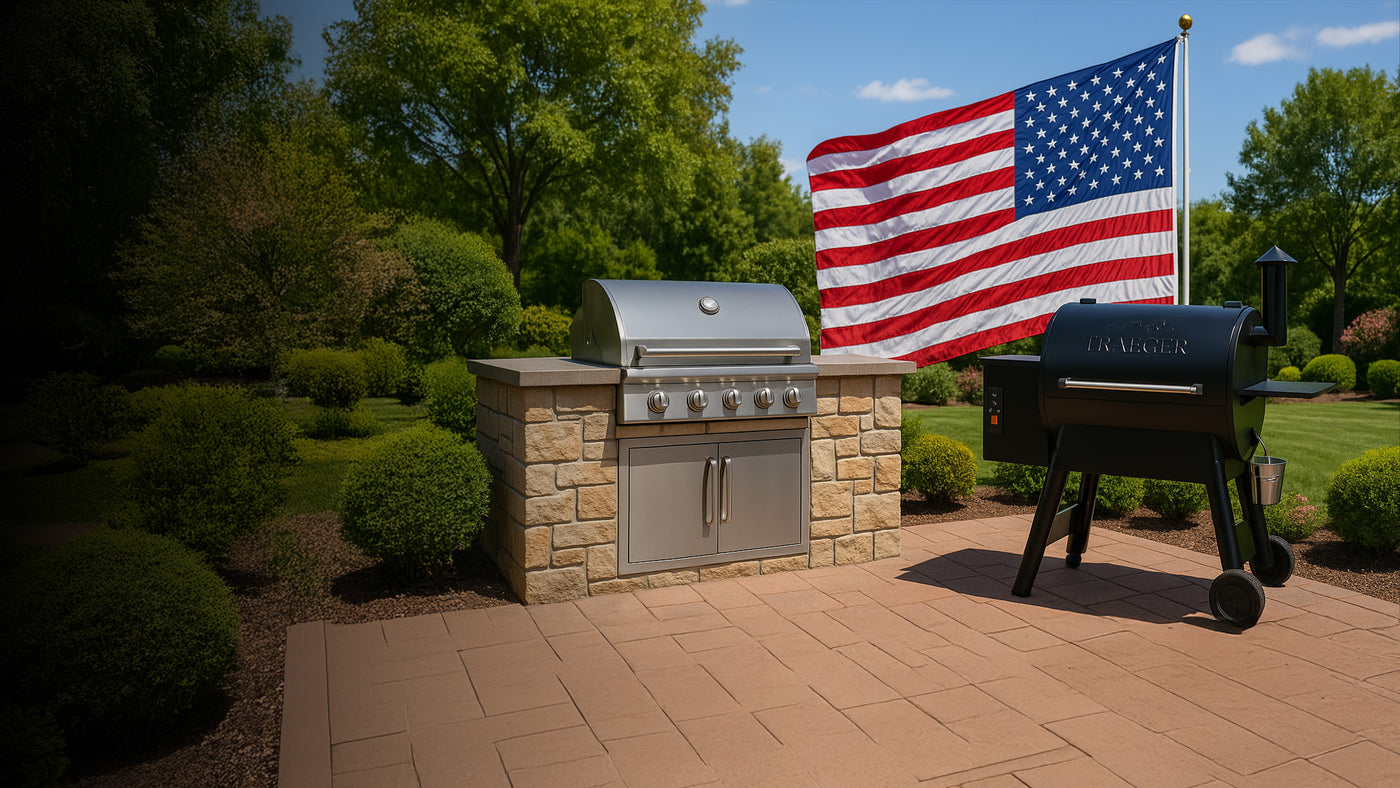 Outdoor kitchen - built-in gas grill next to traeger pellet grill, with american flag in the back for memorial day sale