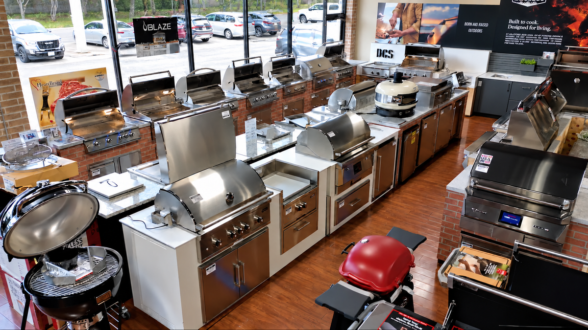 Outdoor kitchen displays and premium built-in grills inside Texas Star Grill Shop’s Southwest Freeway showroom.