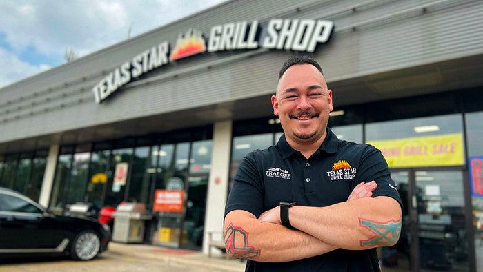Texas Star Grill Shop West U location with team member smiling in front of store