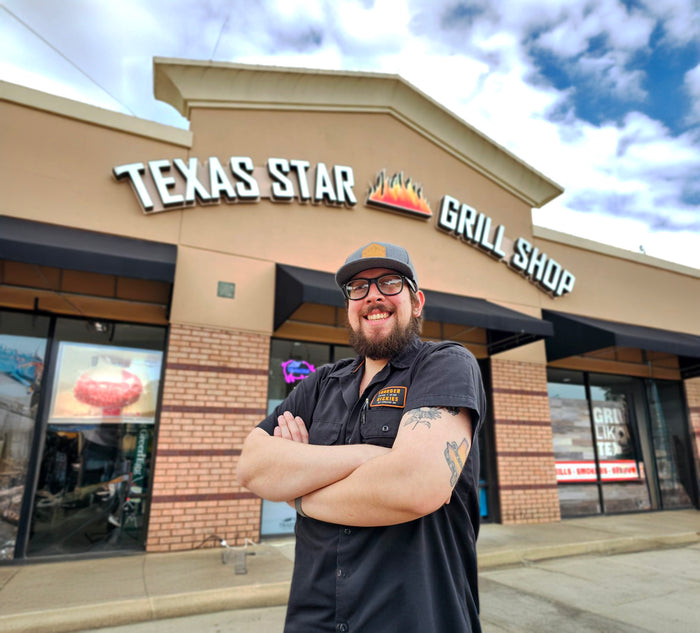 Texas Star Grill Shop Woodway storefront with employee posing confidently