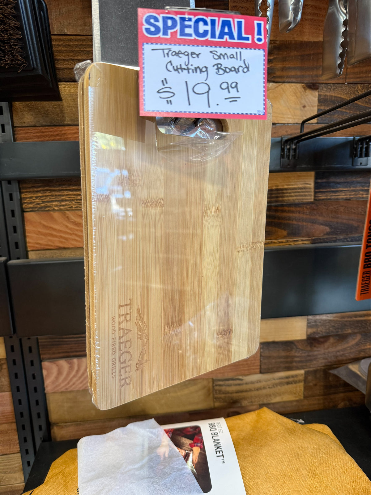 Traeger small wood cutting board with rounded corners, handle opening and engraved Traeger logo