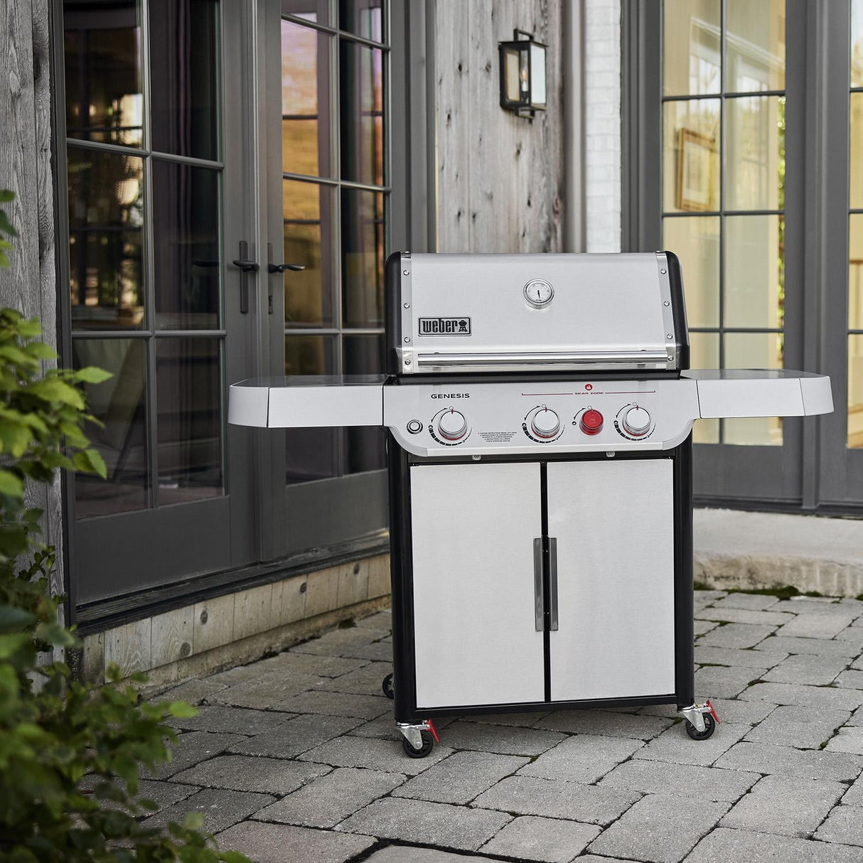 Weber Genesis SP-S-325 grill placed on patio outside double glass doors