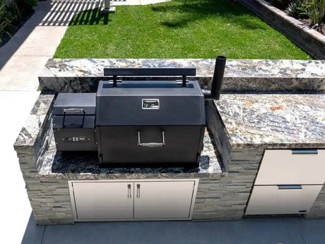 Yoder Smokers YS640s built-in pellet grill installed in a luxury backyard outdoor kitchen setup