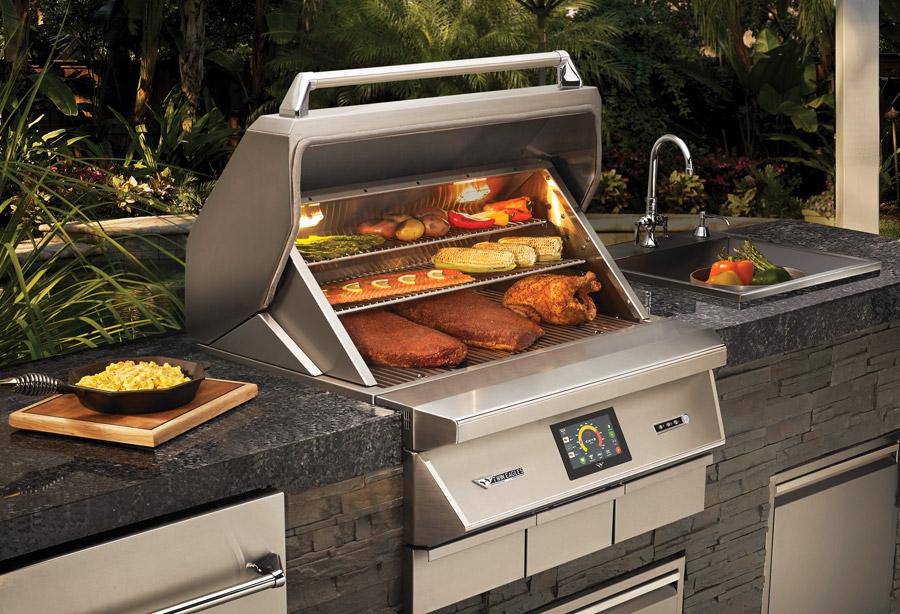 Twin Eagles 36-inch built-in pellet grill with touchscreen controls, loaded with brisket, chicken, corn, and vegetables in a luxury outdoor kitchen.